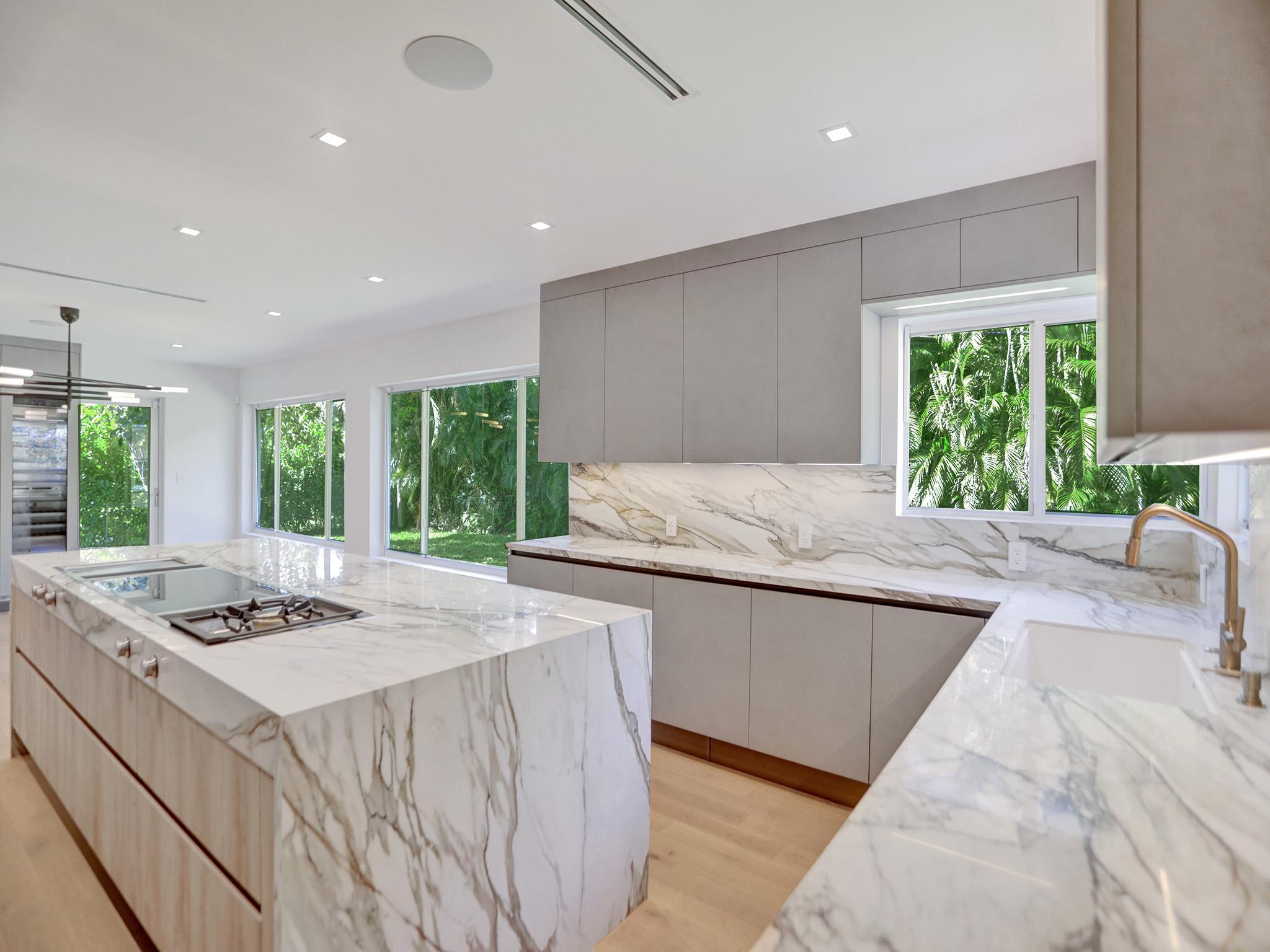 Wide Miami Veneta kitchen with marble island and layout showing the golden triangle