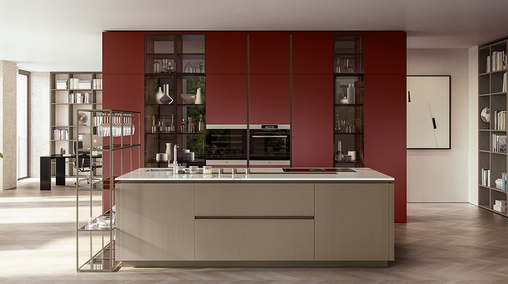 Veneta Cucine kitchen with a freestanding island in front of a red wall of tall cabinets